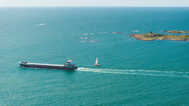 Drone shot of cargo vessel sailing on open sea during daytime