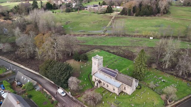 Low Aerial Drone View of St John the Baptist Church Cranford in Northamptonshire Countryside