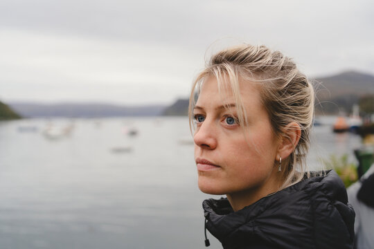 Thoughtful woman contemplating near lake