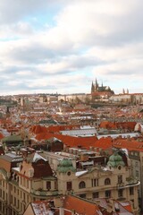 Obraz premium Panoramic view of Prague Castle rising above the river with bridges, historic rooftops 