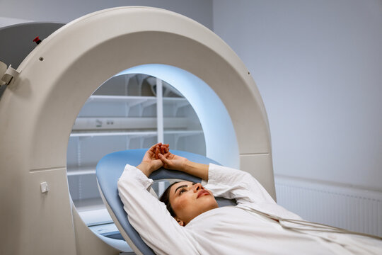 Female patient undergoing MRI scan at clinic