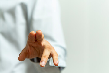 Fototapeta na wymiar Close up of a person's hand reaching out, hinting at interaction or selection. Touching concept.