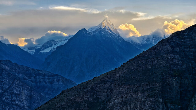 Mountain shadow trail in Himachal Pradesh, India at sunset with dramatic light on Himalayan peaks and deep valley silhouettes, capturing cinematic high altitude landscape. Photo taken in September2026