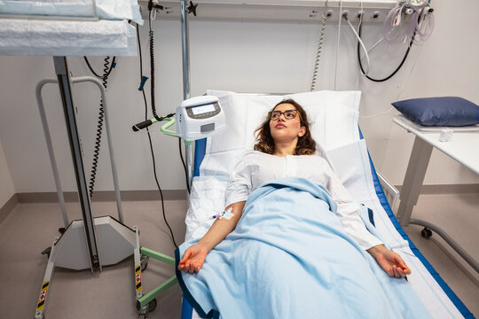 High angle view of female patient lying on bed in hospital