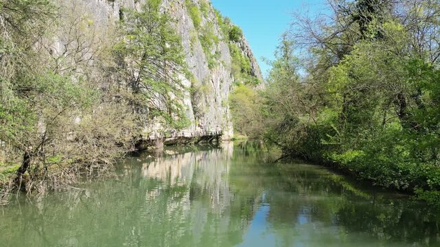 Drone Approaching Cliffside Bridge Over River at Iskar Panega Trail