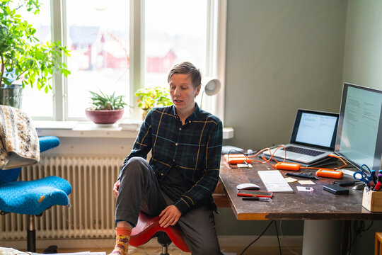 High angle view of person sitting at desk in home office