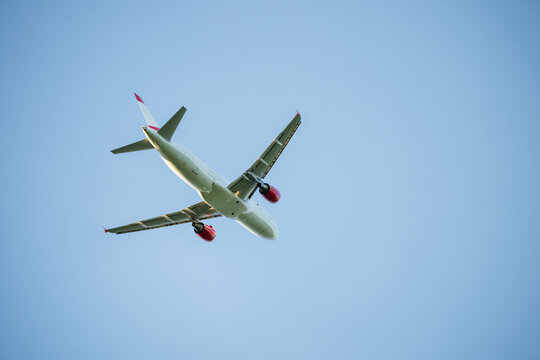 Low angle view of commercial airplane flying against blue sky
