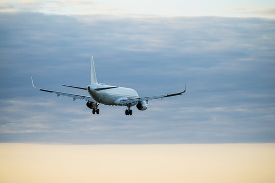 Beautiful view of passenger airplane flying against cloudy sky