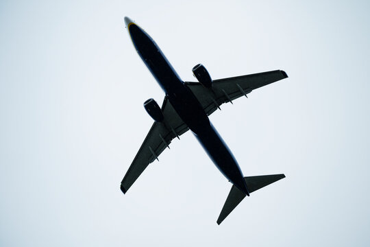 Directly below shot of passenger aircraft flying against clear sky