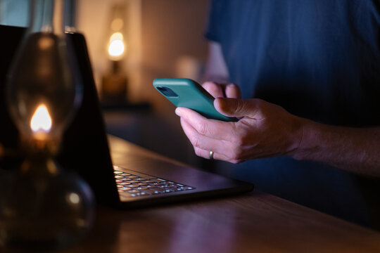 Midsection of freelance worker doing multi-tasking with laptop and smart phone