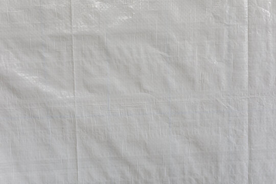 Close-up abstract view of a durable white woven tarp texture and background