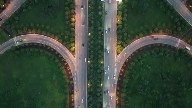Blue hour drone video shot of curved highway ramps connected to multilane expressway in Dong Anh District Hanoi.