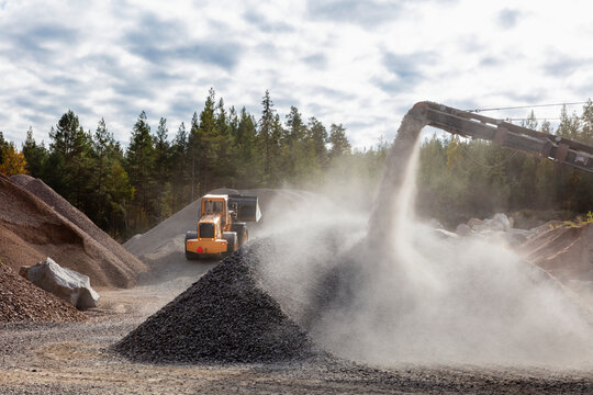 Industrial conveyor belt machine unloading crushed rock at quarry