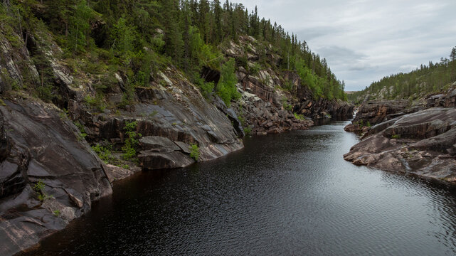 Scenic view of river amidst rock canyons against sky
