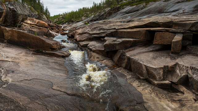 View of stream flowing amidst rock formations
