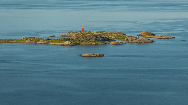 Lighthouse on rocks surrounded by sea water
