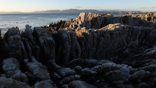 rocky coastline of DeKelders, Gansbaai, South Africa at sunset