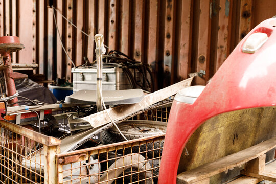 A messy pile of scrap metal and old car parts.