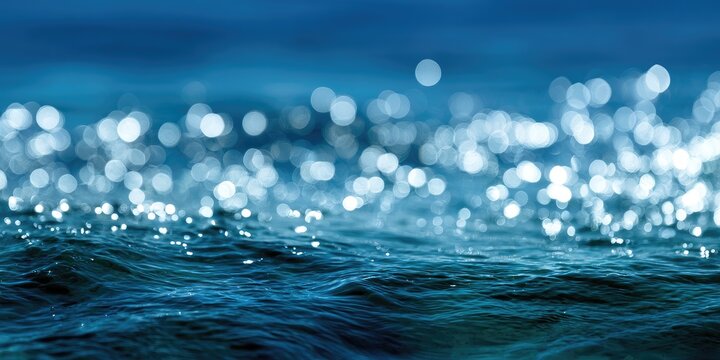 Gentle blue waves with bright sunlit sparkles on the surface