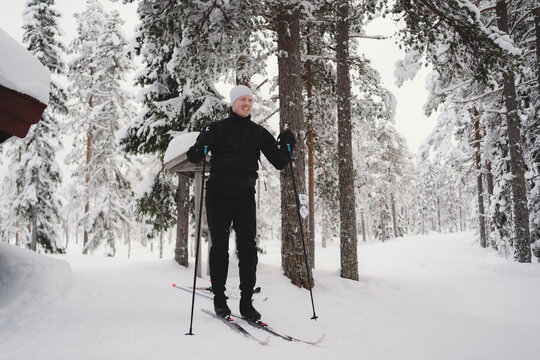 Full length of man skiing in winter forest