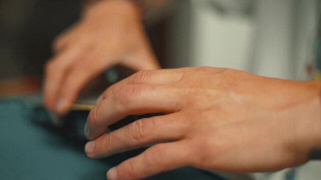 Close look at hand working on device repair in workshop during afternoon