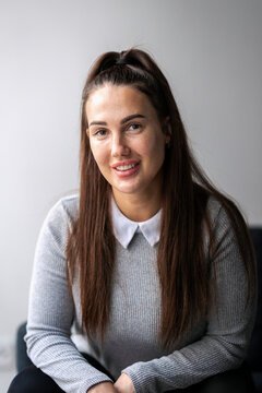 Portrait of smiling young female business entrepreneur with long hair