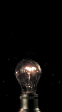 Super slow motion three light bulbs explode. On a black background.Filmed on a high-speed camera at 1000 fps.