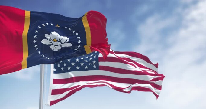 Mississippi state flag waving with the American flag on a clear day. Magnolia state. Seamless 3d render animation. Slow motion loop. Selective focus