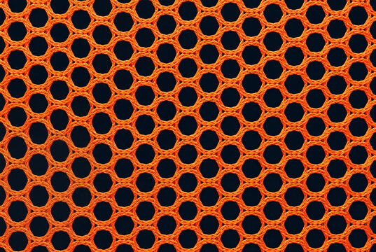 Bright orange mesh fabric texture with a hexagonal pattern on a dark background