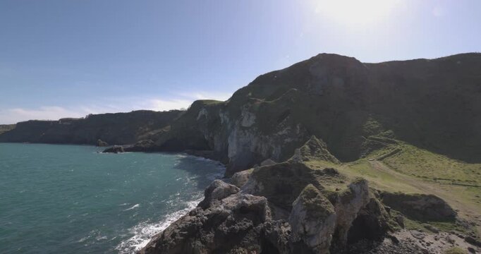 slow panning shot revealing Kinbane Castle and the beautiful cliffs