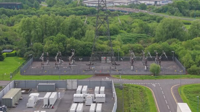 Aerial Orbit of Substation with nearby BESS Battery Energy Storage System installation made of lithium-ion. Modern green energy infrastructure, smart grid technology, sustainable power solutions. UK.