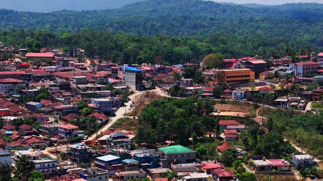Close up shot of suntikoppa village with roads, trees and mountains at coorg, Madikeri, karnataka, india. day time, slight pan shot, drone shot, 4k.