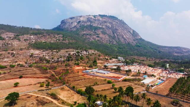 Crop field lands with venture lands, trees and nandi hills at Bangalore, karnataka, india. day time, crane shot, drone shot, 4k.