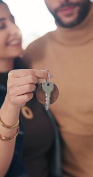 Couple, moving in and hand with key in new home, smile and property investment with partner. Happy man, woman and relocation with keychain for mortgage, future real estate and face at dream house