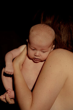 Sunlight shining on male toddler being embraced by shirtless father