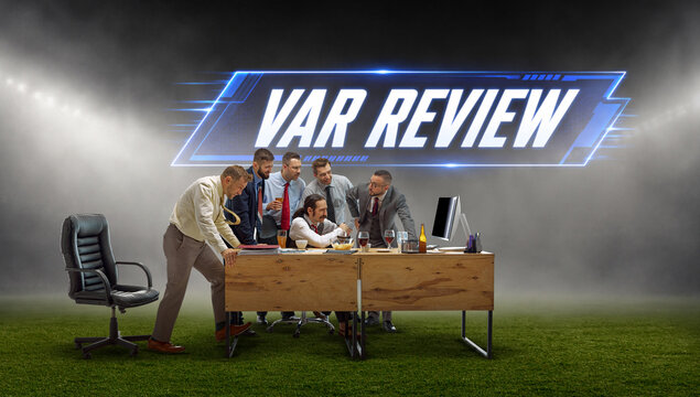 Business fans watching soccer decision with var review text on stadium field. Concept of video referee check, office watch party, football match suspense and disputed goal.