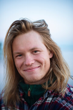 Portrait of smiling man with long blond hair