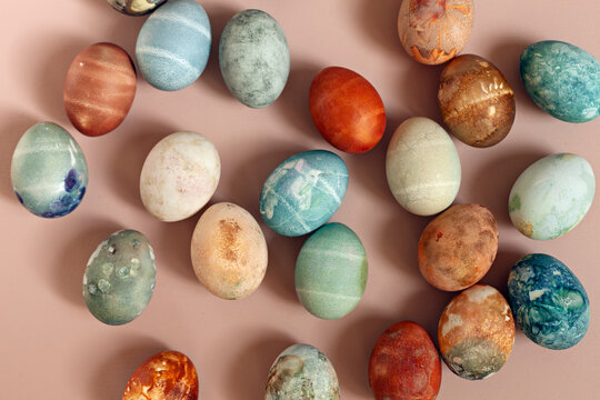 Directly above shot of dyed eggs like stones on beige background