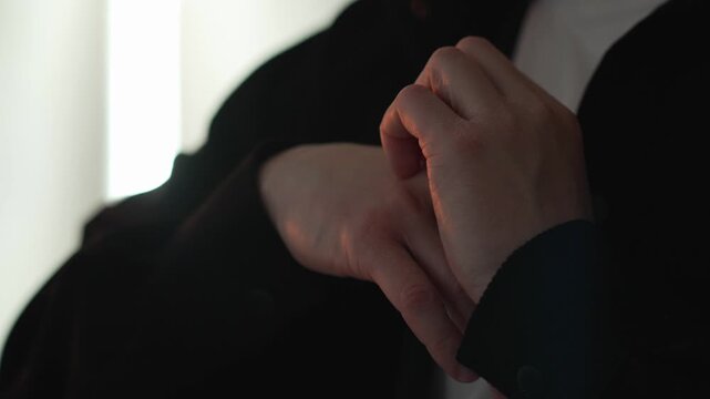 A man scratching his hand close-up due to allergies or dry hands.