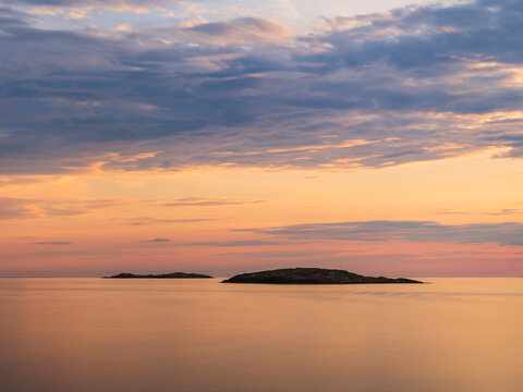 Scenic view of beautiful sea against dramatic sky at dusk
