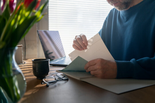 Male entrepreneur reviewing documents while working from home