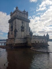 Fototapeta premium Scenic view of the historic Belem Tower (Torre de Belem) on the Tagus River bank, Lisbon, Portugal.