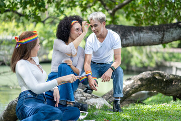 Fototapeta premium Group for human rights.Lesbian, ally, happy people for LGBTQ support in nature,relax with identity equality. Friends, pride flag, women in park with smile for bonding, community. Pride month. concept