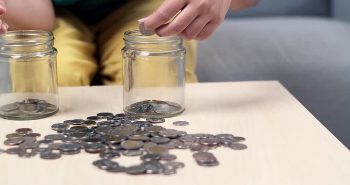 A person sorts and counts coins at home focusing saving strategies and financial management.