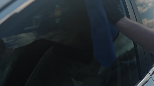 White Technician Cleaning Interior Windshield Cabin, Gloved Hand And Microfiber Removing Fingerprints