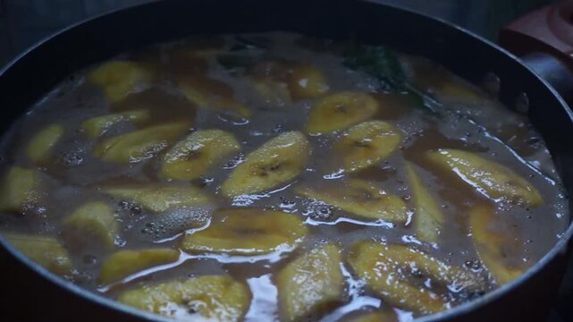 Close up shot of boiling kolak pisang or sweet banana soup with coconut milk and palm sugar in a pan