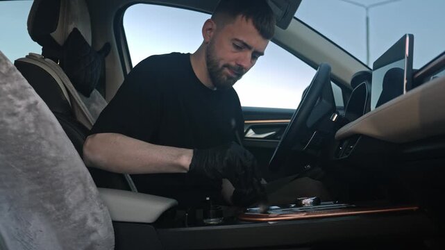 Caucasian Man Inspecting Gearshift And Center Controls Inside Car, Focused Movements, Black Gloves, Careful