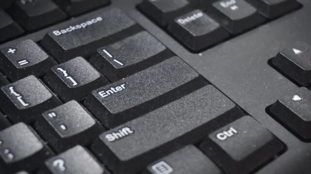 A man pressing the Enter key on a modern computer keyboard, close-up macro detail, user POV, shallow depth of field, single person. Sending a message, purchasing something, accepting rules