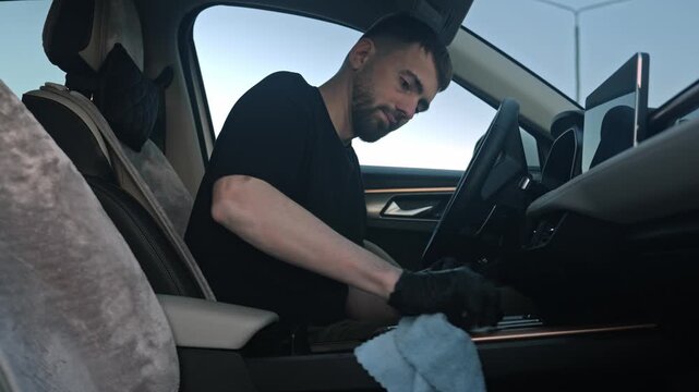 White Man Technician Polishing Dashboard Trim With Microfiber, Black Gloves, Careful Circular Motions, Highend