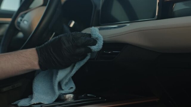 Closeup Hand Polishing Center Console Trim With Microfiber, Low Light Interior, Careful Circular Motions